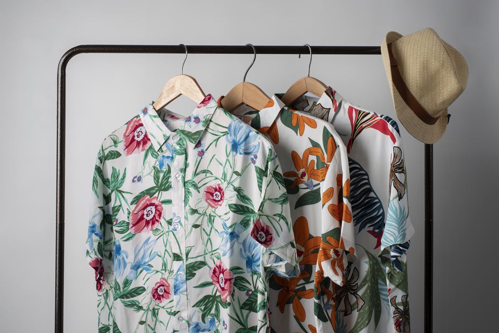 clothing rack with hawaiian shirts with floral pri